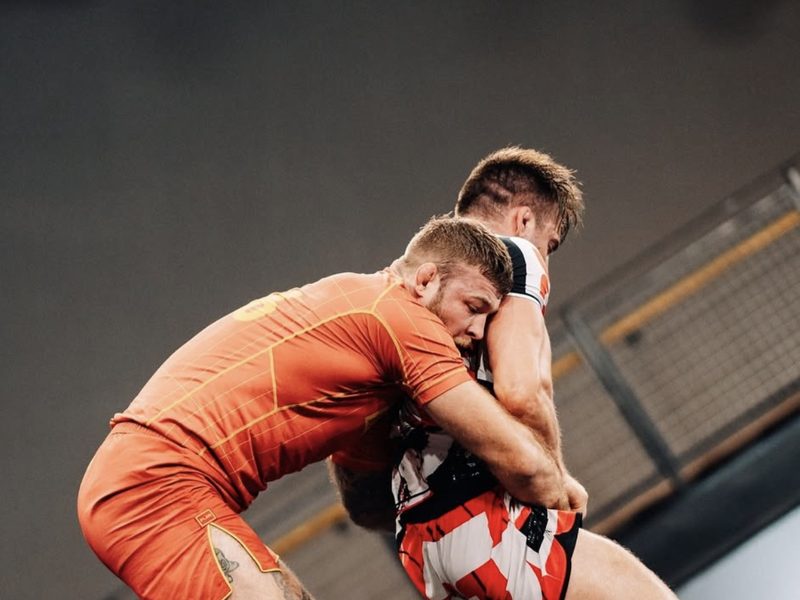 Declan Moody fighting for position in a standing clinch during a match