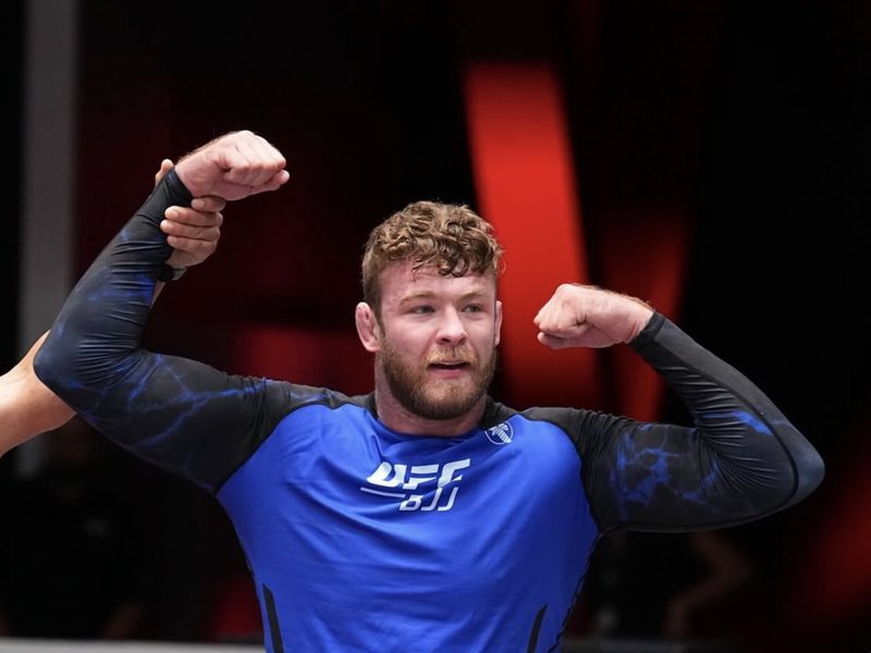 Declan Moody flexing after a match at a UFC BJJ event