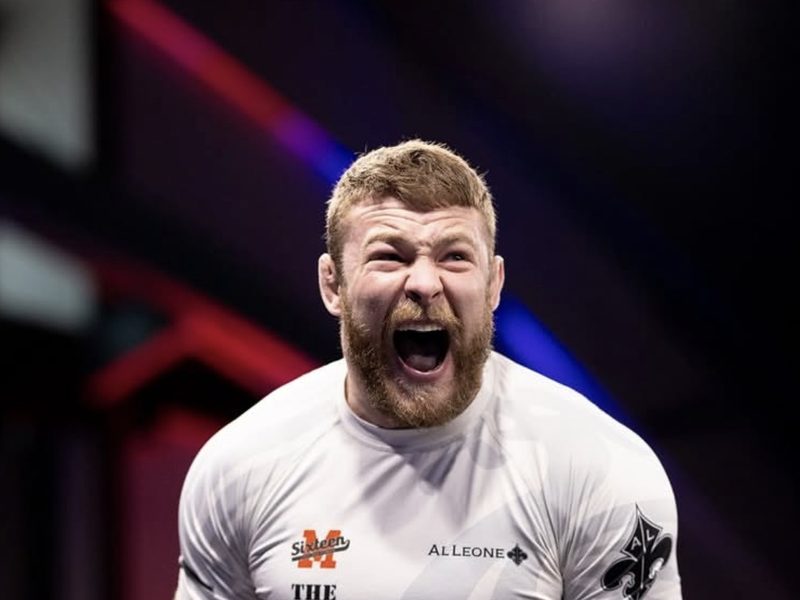 Declan Moody roaring after a match in a white B-Team rashguard