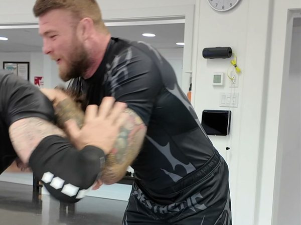 Declan Moody driving a training partner's head down during a hand-fighting drill